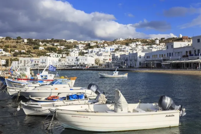Framed Print : Small boats in harbour, whitewashed Mykonos Town (Chora) with windmills on hillside Framed Print : Small boats in harbour, whitewashed Mykonos Town (Chora) with windmills on hillside