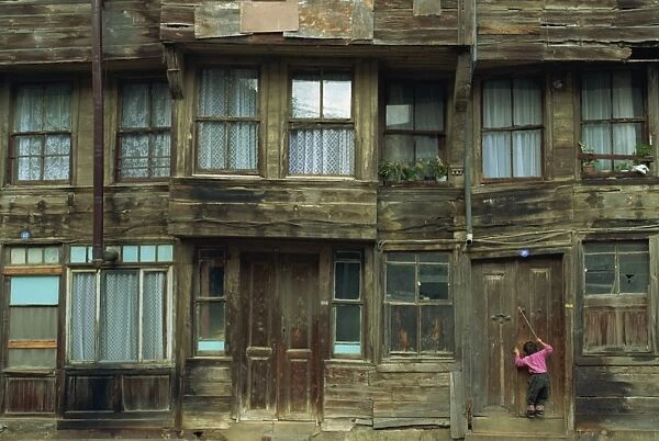 Small child and wooden house, Heybeliada, Princes Islands (Kizil Adalar), Turkey, Eurasia