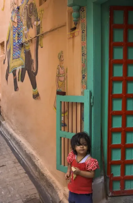Framed Print : Small girl standing in doorway of typical house decorated Framed Print : Small girl standing in doorway of typical house decorated