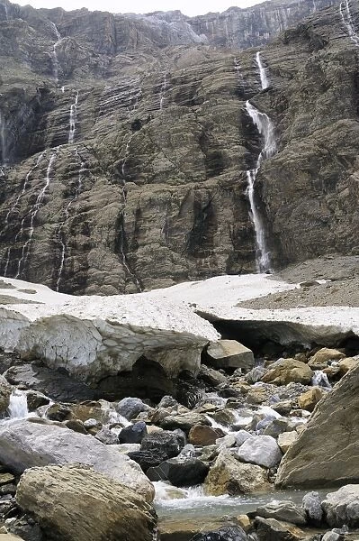 Small glacier and source of the Gave River at foot of waterfalls at the Cirque de Gavarnie, Pyrenees National Park, Hautes-Pyrenees, France, Europe