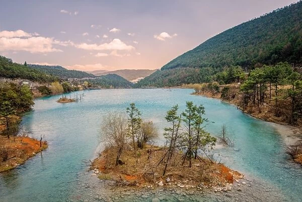 Small island with trees at Baishuihe, White Water River in Yunnan, China, Asia