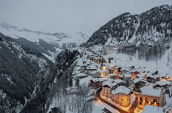 Small village of Pianazzo on top of snowcapped mountain after a snowfall, Madesimo