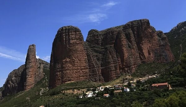 The small village of Riglos below huge conglomerate towers rising over a thousand feet above the plains near Heusca and Jaca, northern Aragon, southern Pyrenees region