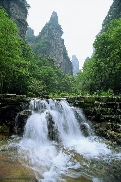 Small waterfall in spectacular limestone outcrops and forested valleys of Zhangjiajie Forest Park in Wulingyuan Scenic Area, UNESCO World Heritage Site, Hunan