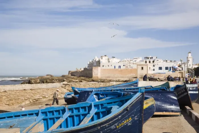 Framed Print : Small wooden fishing boats on seafront with white buildings of the Medina beyond Framed Print : Small wooden fishing boats on seafront with white buildings of the Medina beyond