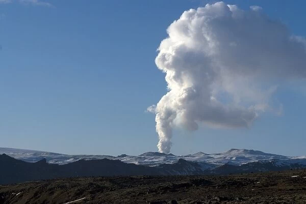 Smoke plume rising over glacier, Eyjafjallajokull volcano, Iceland, Polar Regions