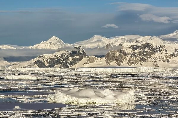 Snow-capped mountains surround Pleneau Island, Antarctica, Southern Ocean, Polar Regions
