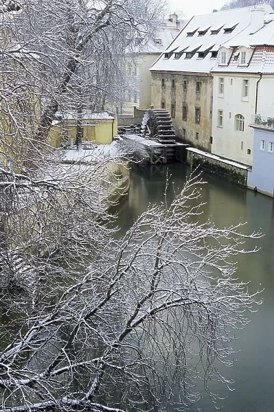 Snow-covered Certovka Canal and water wheel at Kampa Island, Mala Strana suburb