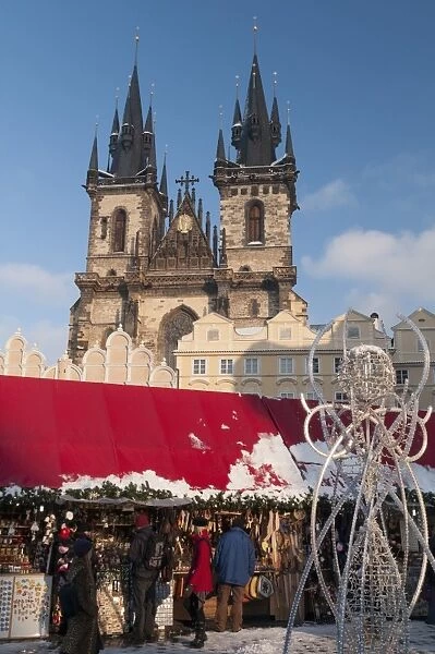 Snow-covered Christmas Market and Tyn Church, Old Town Square, Prague, Czech Republic, Europe
