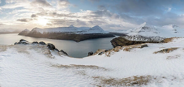 Snow-covered cliffs and mountains along Funningur fjord, Eysturoy Island, Faroe Islands, Denmark, Europe