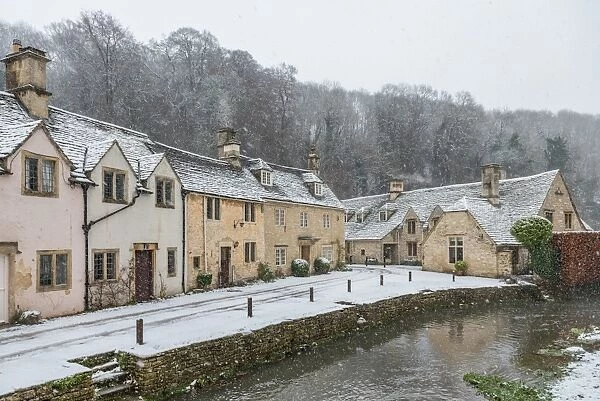 Snow covered houses by By Brook in Castle Combe, Wiltshire, England, United Kingdom