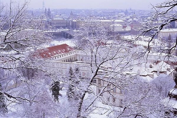 Snow covered Mala Strana and Stare Mesto rooftops, Prague, Czech Republic, Europe
