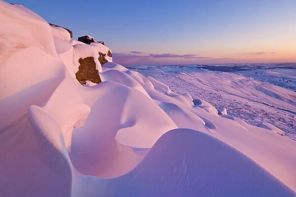 Snow covered moorland at sunset on Stanage Edge, Peak District National Park