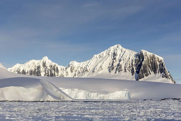 Snow-covered mountains and dense sea ice in Neumayer Channel, Palmer Archipelago
