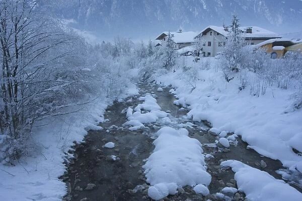 Snow covered river and houses, Mayrhofen ski resort, Zillertal Valley, Austrian Tyrol