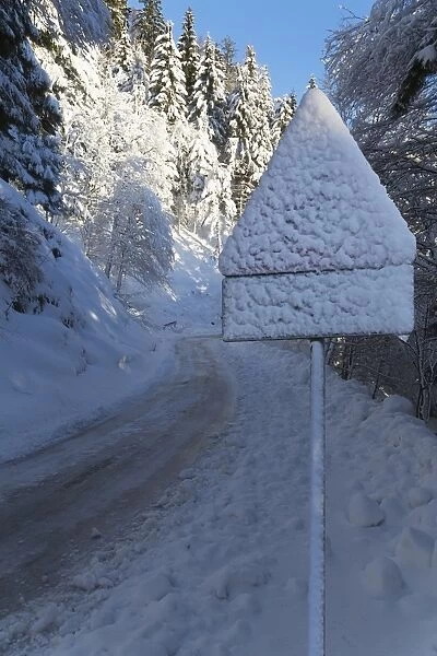 Snow-covered road sign in the Italian Alps in winter, Aosta Valley, Italy, Europe