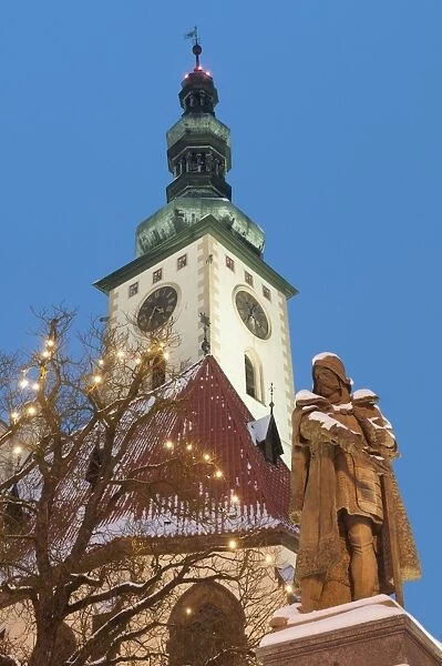 Snow-covered statue of Jan Zizka and Church of Transfiguration of Our Lady on Mount Tabor, Jihocesky, Czech Republic, Europe