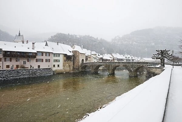 Snow covered town of St. Ursanne, Jura, Switzerland, Europe