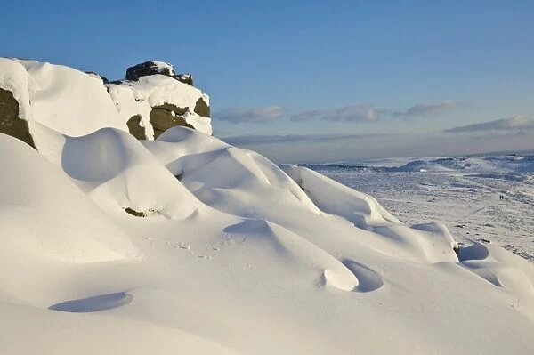 Snow drifts and snow covered moorland at Stanage Edge, Peak District National Park