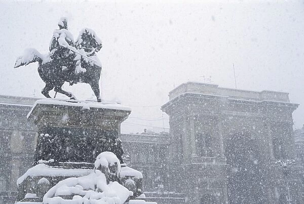Snow falling on the statue of Vittorio Emanuele, Milan, Lombardy, Italy, Europe