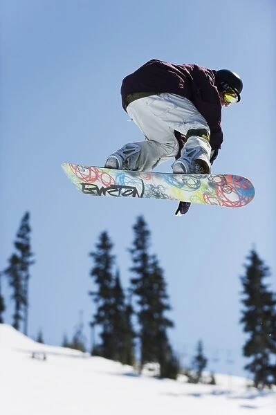 A snowboarder jumping at Telus Half Pipe competition 2009, Whistler mountain