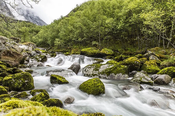 Snowmelt river running strongly in Briksdal Valley, Olden, Norway, Scandinavia, Europe