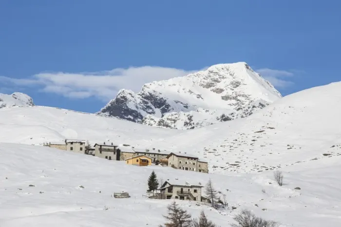 Framed Print : The snowy huts frame Peak Tambo in the background, Andossi, Spluga Valley, Province of Sondrio