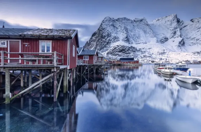 Framed Print : Snowy mountains and the typical red houses reflected in the cold sea at dusk, Reine Framed Print : Snowy mountains and the typical red houses reflected in the cold sea at dusk, Reine