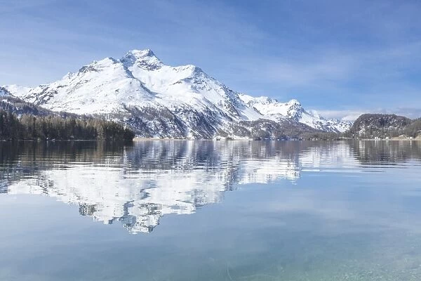 Snowy peaks reflected in the clear water of Lake Sils, Maloja, Canton of Graubunden