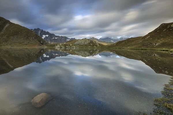 The snowy peaks are reflected in Fenetre Lakes at dawn, Ferret Valley, Saint Rhemy