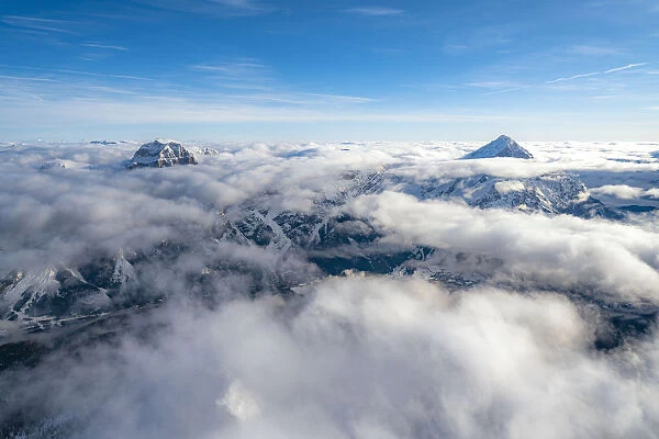 Sorapis group and Antelao emerging from clouds, aerial view, Dolomites, Belluno province