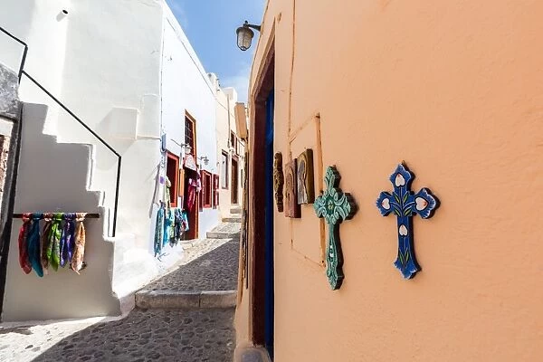Souvenir crosses on the outside of a shop on a street in Oia, Santorini, Cyclades