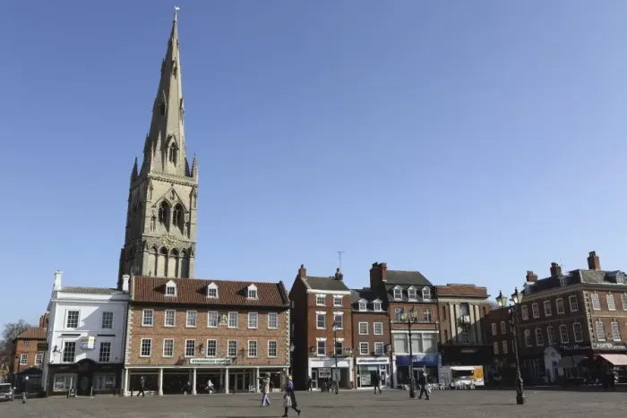 Framed Print : The spire of St. Mary Magdalene church rises over building on the Market Square in Framed Print : The spire of St. Mary Magdalene church rises over building on the Market Square in