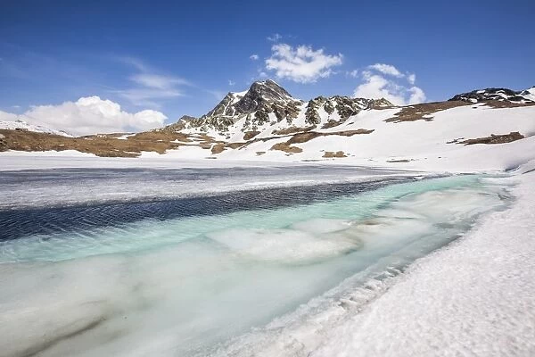 Spring is coming and lake Emet in the Spluga Valley is slowly thawing, Lombardy, Italy, Europe
