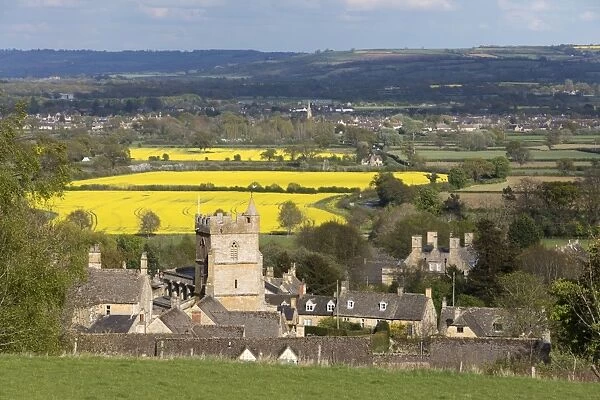 St. Lawrence church and oilseed rape fields, Bourton-on-the-Hill, Cotswolds, Gloucestershire