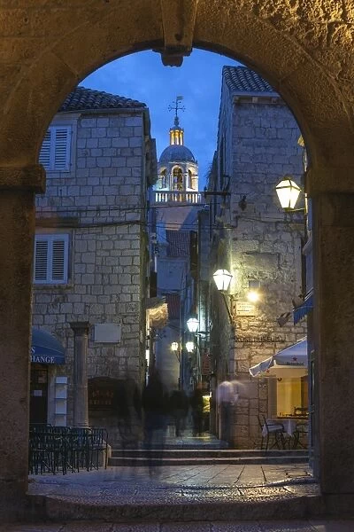St. Marko Bell Tower and Land Gate illuminated at dusk, Korcula Town, Korcula, Dalmatia, Croatia, Europe