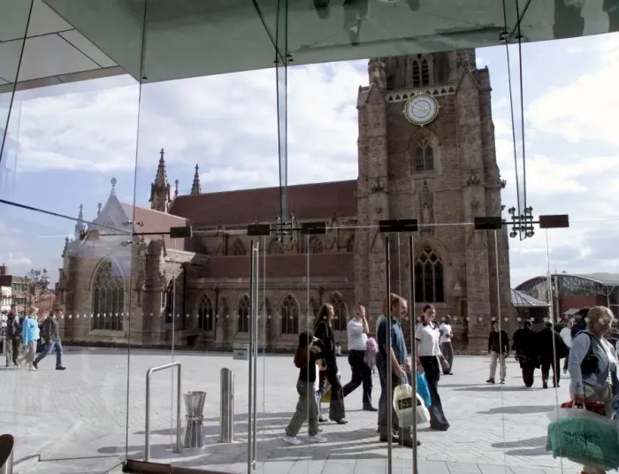 Framed Print : St. Martins in the Field church visible through glass window of shopping complex Framed Print : St. Martins in the Field church visible through glass window of shopping complex