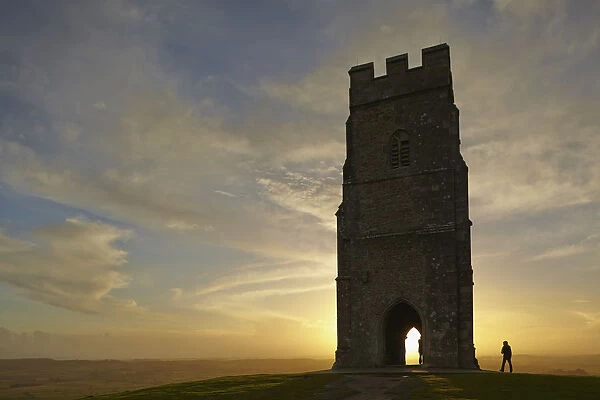 St. Michaels Tower silhouetted at sunset, on the summit of Glastonbury Tor