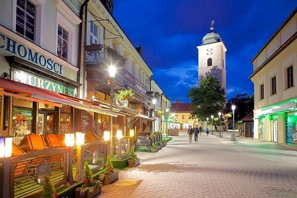 St. Stanislaw and St. Adalbert Parish Church Clock Tower and street scene at dusk, Rzeszow, Poland, Europe