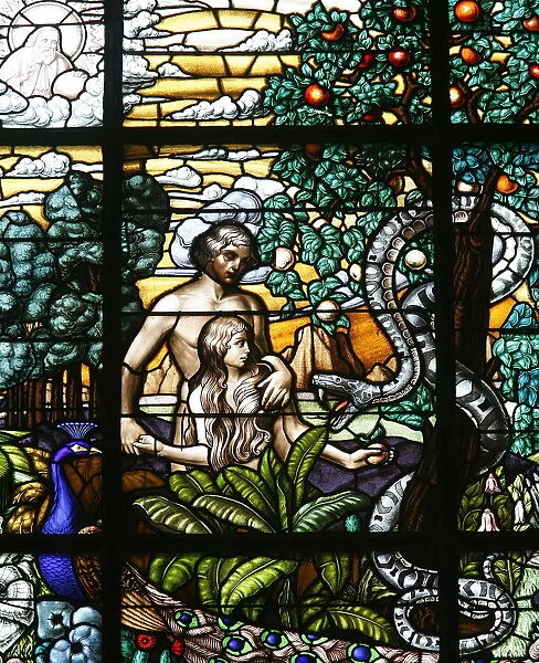 Stained glass of Adam and Eve in the Garden of Eden, Vienna, Austria, Europe