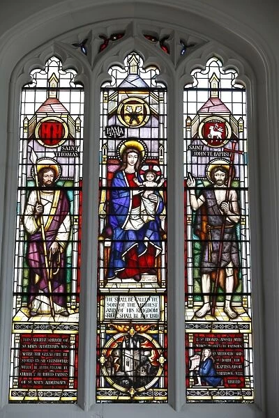 Stained glass window by Lawrence Lee showing the Virgin Mary and Child flanked by St