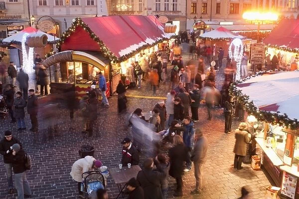 Stalls and people at Christmas Market at dusk, Old Town Square, Stare Mesto, Prague, Czech Republic