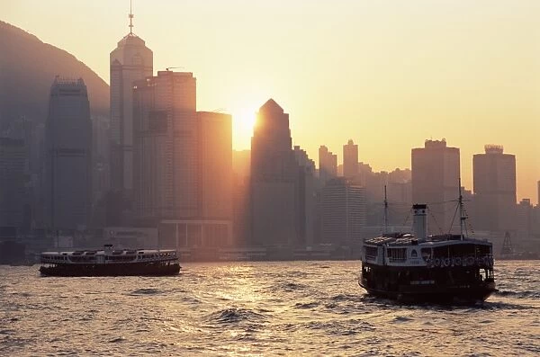 Star ferries, Victoria Harbour and Hong Kong Island skyline at sunset, Hong Kong