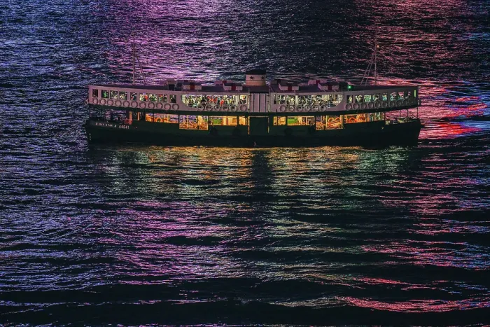 Framed Print : The Star Ferry at night with the reflections of the buildings in the harbour water in Hong Kong, China Framed Print : The Star Ferry at night with the reflections of the buildings in the harbour water in Hong Kong, China