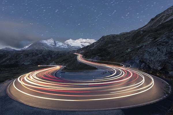 Star trail and lights of car traces, Bernina Pass, Poschiavo Valley, Engadine, Canton of Graubunden