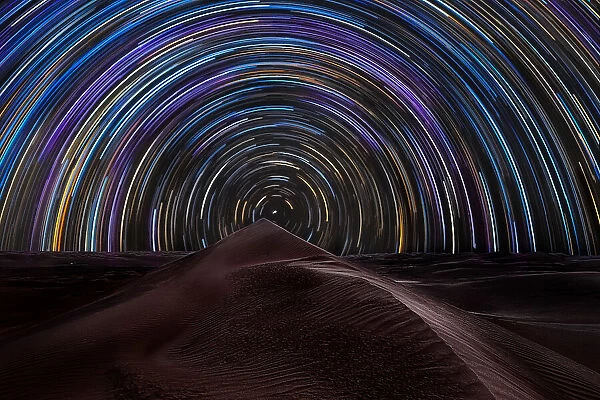 Star trail over the sand dunes of Rub al Khali desert, Oman, Middle East