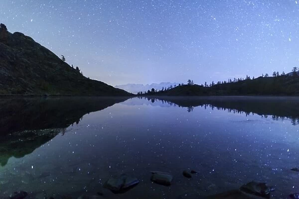 Starry night on Mount Rosa seen from Lake Vallette, Natural Park of Mont Avic, Aosta Valley