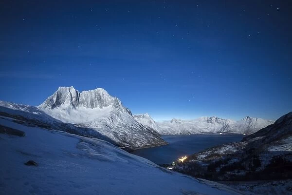 Stars of the polar night on the Senjahopen peak and frozen sea, Senja, Mefjordbotn