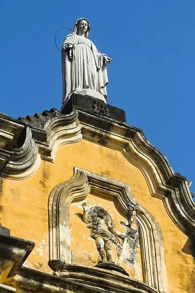 Statue atop the baroque facade of the Iglesia de la Recoleccion church, built 1786, in this historic northwest city, Leon, Nicaragua, Central America
