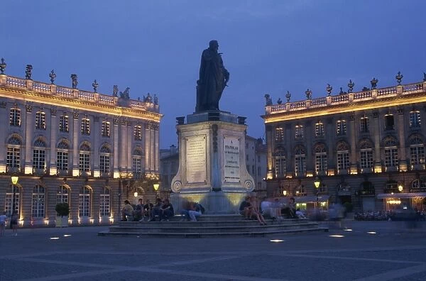 Statue and buildings illuminated at night in the Place Stanislas in Nancy